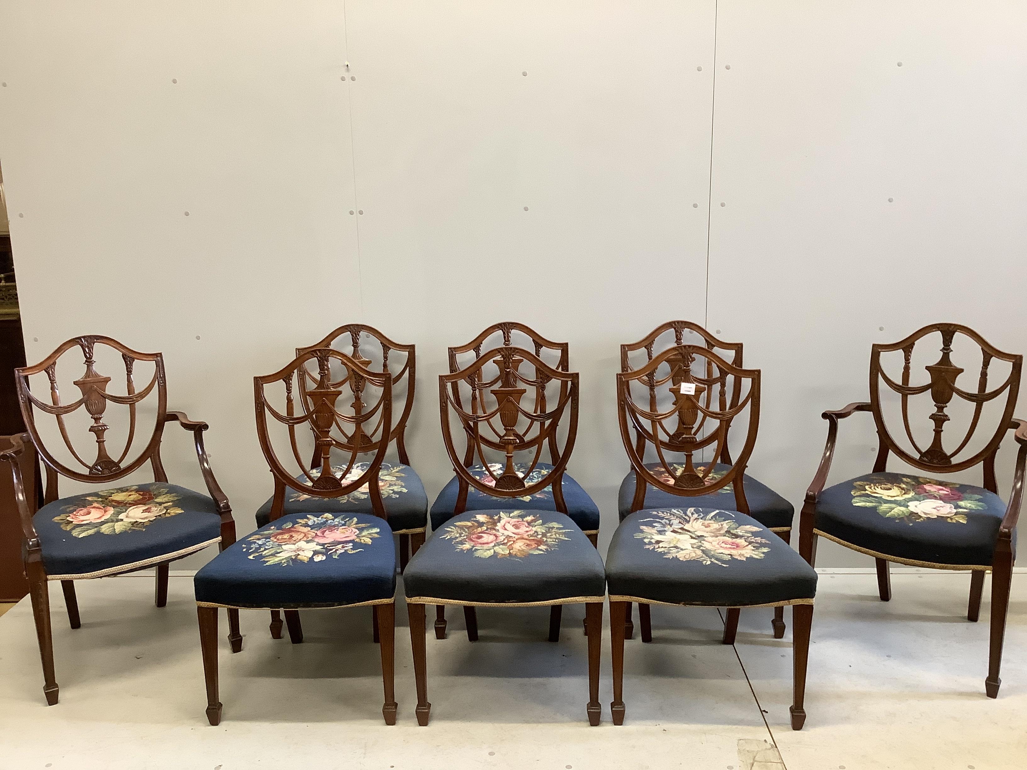 A set of eight Edwardian Hepplewhite style mahogany dining chairs with tapestry seats, two with arms